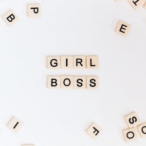 Image of scrabble tiles that spell the words: Girl Boss