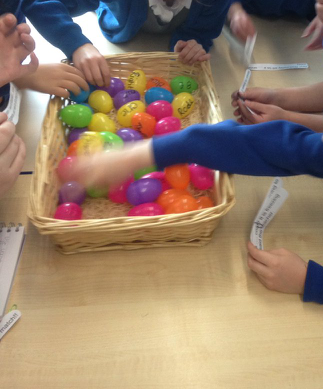 Children grabbing at plastic eggs