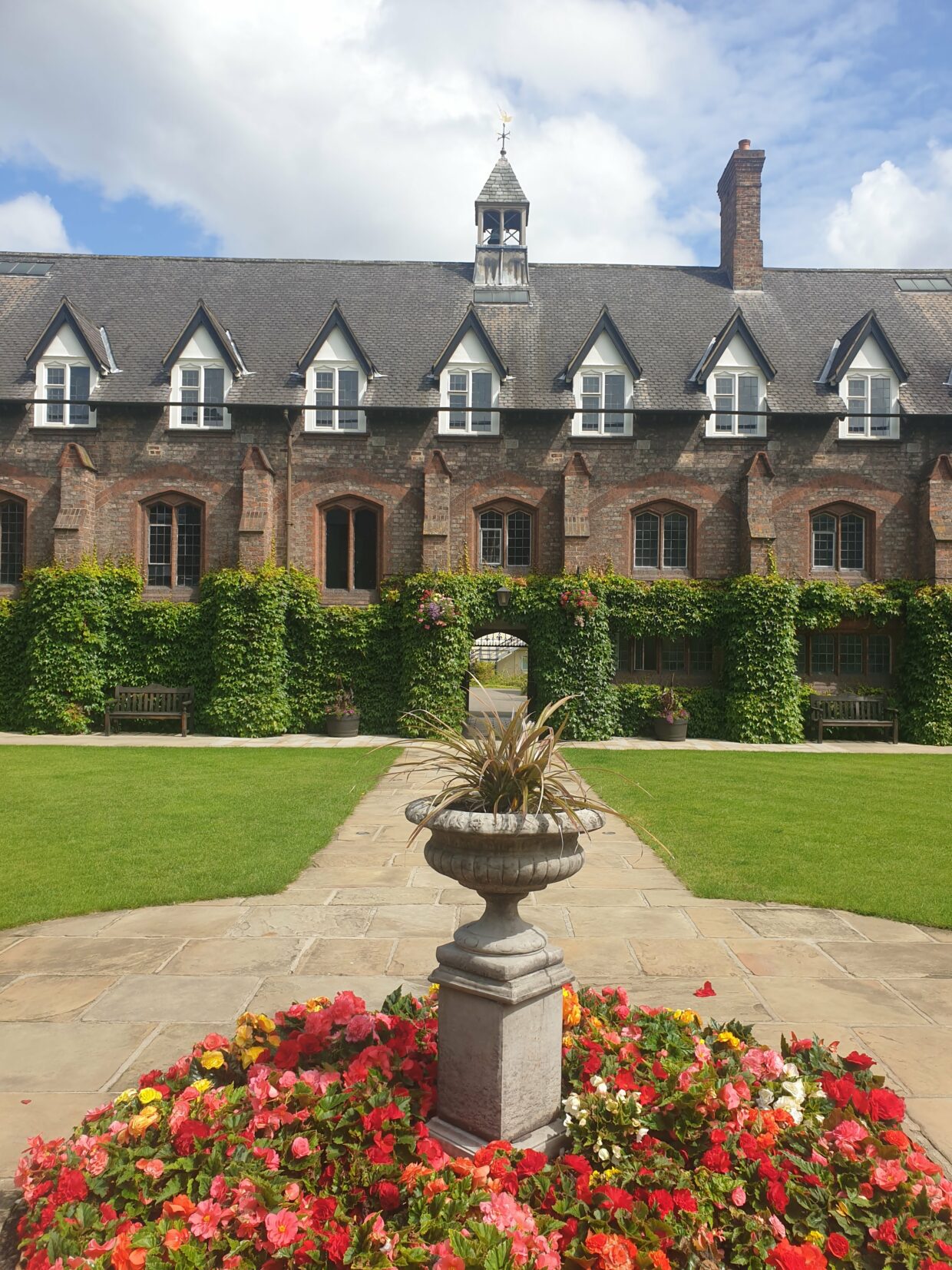A view of Quad East with the centre piece and flowers around it.