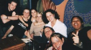 Photo of a group of students smiling and spending time together at a bar.