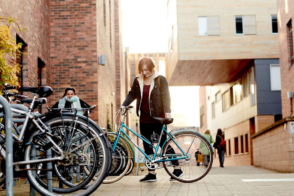 A student with a bike on campus.