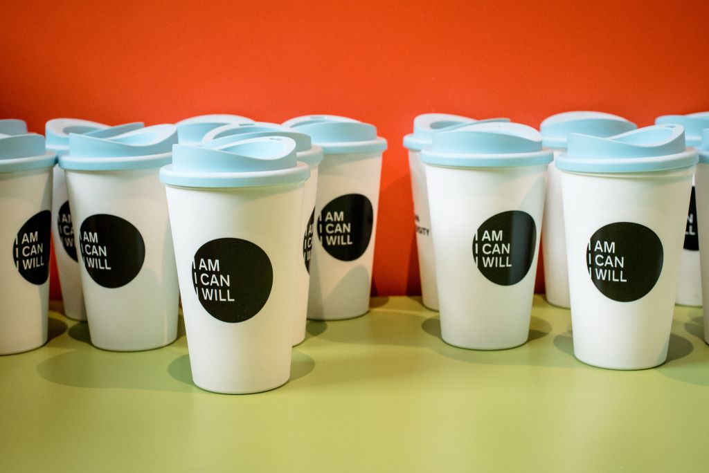 YSJ coffee cups, with labels reading 'I am, I can, I will'.