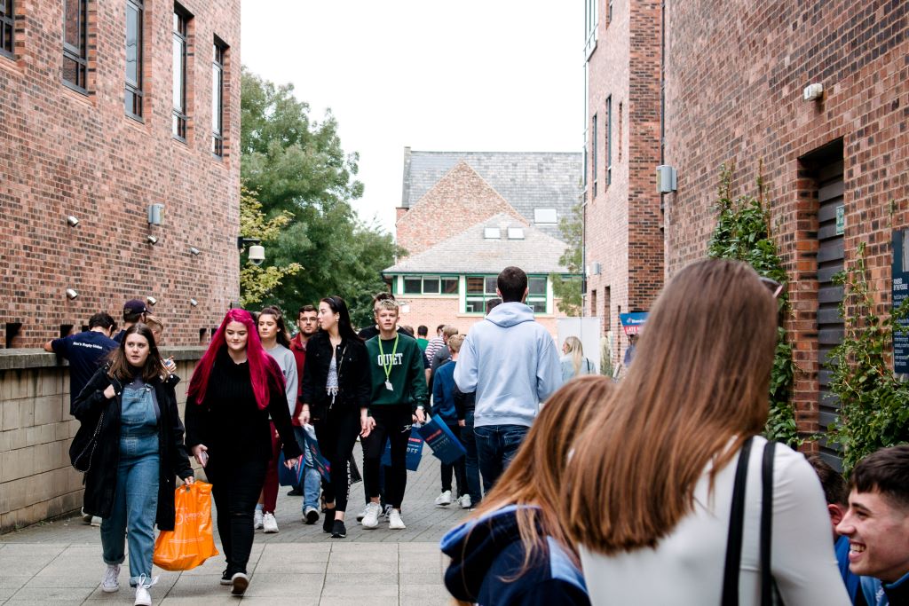 A mixture of students walking through campus during Freshers' week.