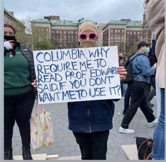 Student protestor holding up sign that reads: Columbia, why require me to read Prof Edward Said if you don't want me to use it?