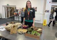 Campus Energy and Environmental Projects Officer Sarah Williams with some of the donated locally grown vegetablesat the Living Lab launch