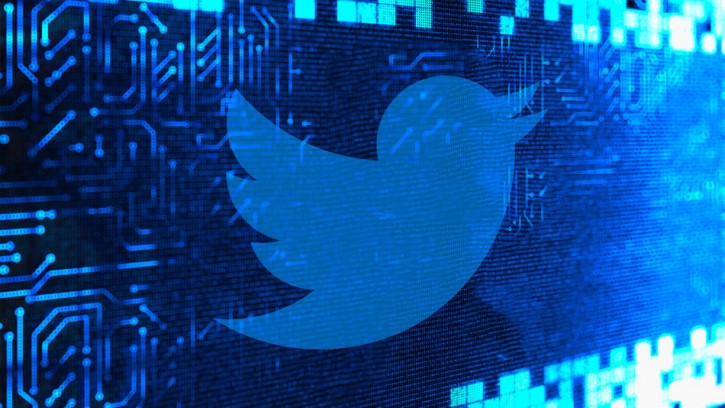 Image of the Twitter logo on a digital-looking background.