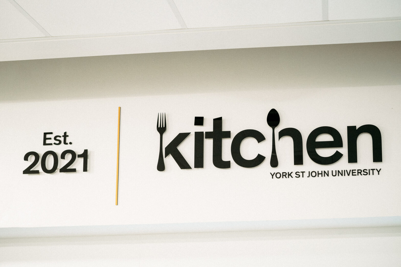 a photo of the black text YSJ Kitchen logo on a white backing board