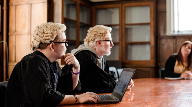 Image of students in a set up courtroom