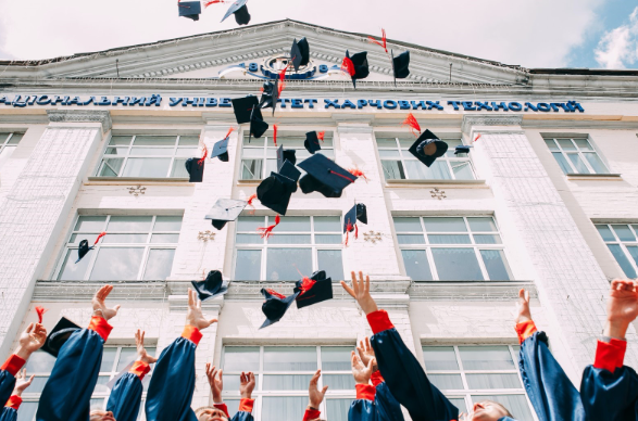 Image of students throwing a cap in the air