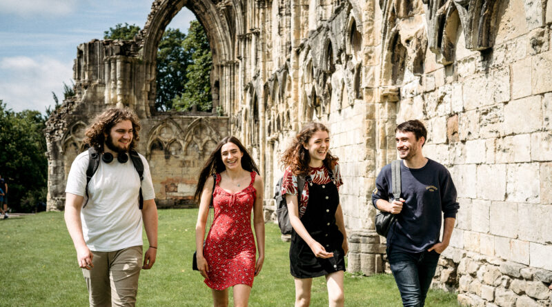 An image of four students walking in Museum Gardens in York.