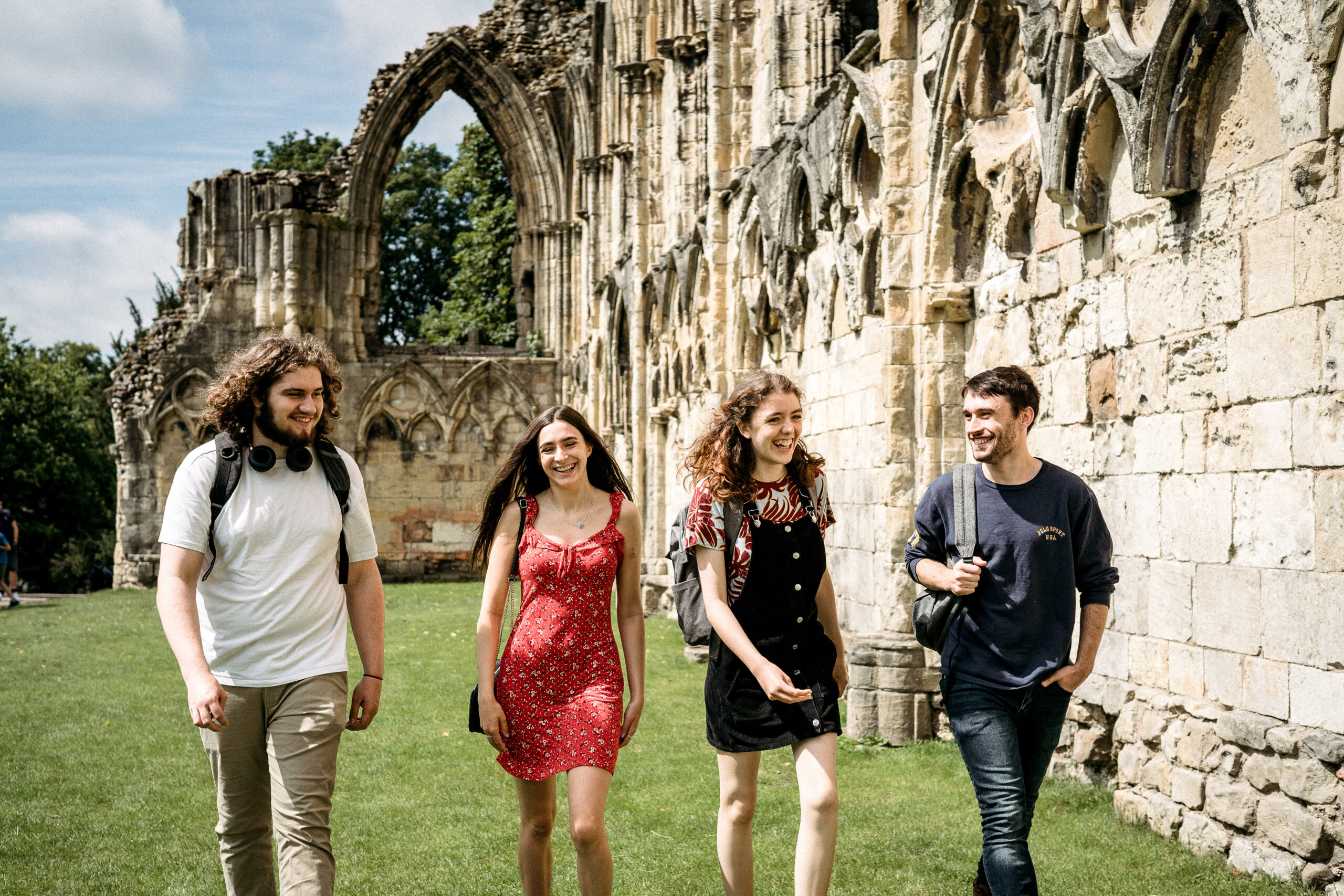 An image of four students walking in Museum Gardens in York.